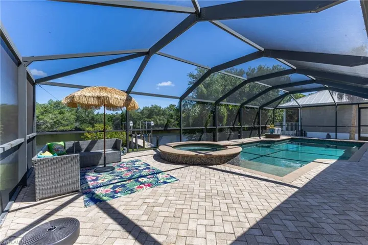 Screened lanai featuring a swimming pool and integrated spa