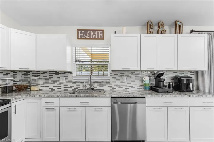 Glass inserts adorn the back splash of the entire kitchen area.