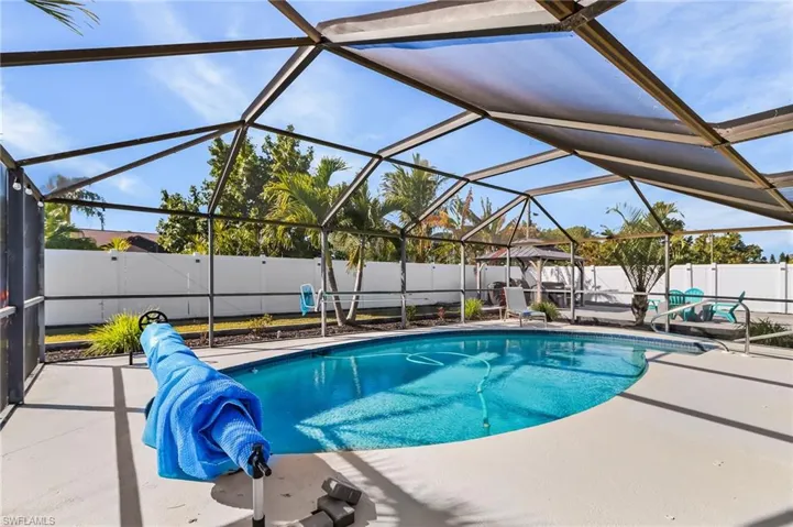 Fully caged and screened, pool has a solar cover.