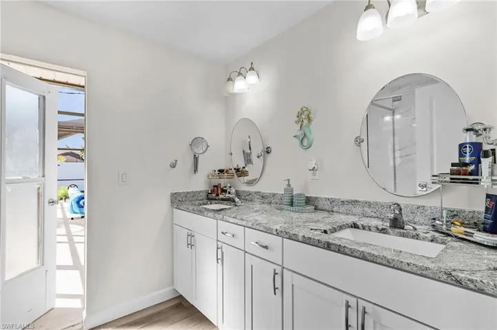 Master bathroom offers two sinks, spacious shower and easy access to the pool deck and spa.