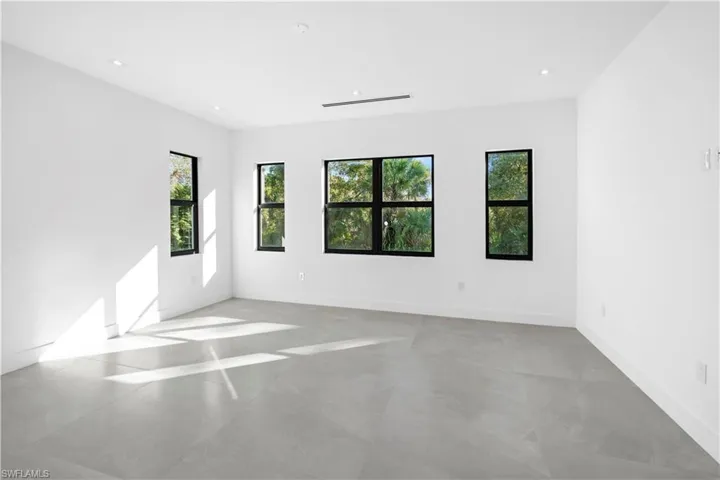 Spare room featuring concrete flooring and recessed lighting