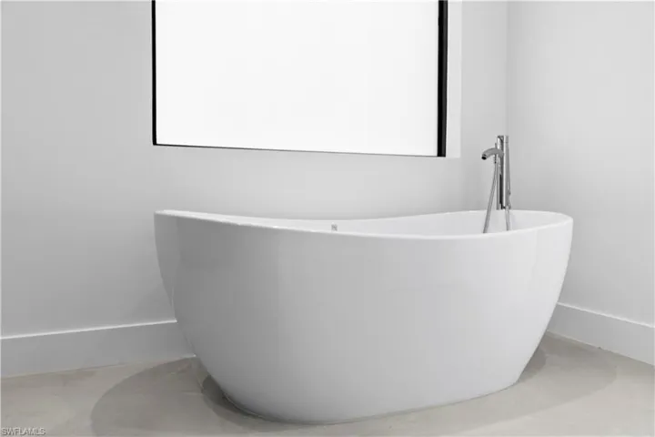Bathroom featuring a freestanding tub and tile patterned floors