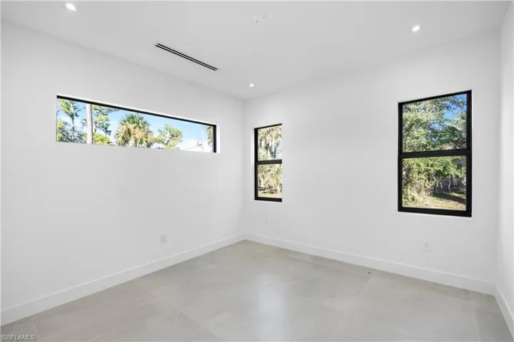 Spare room featuring recessed lighting and baseboards