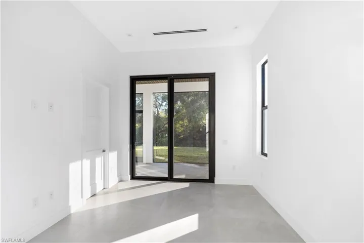 Empty room with concrete floors and baseboards