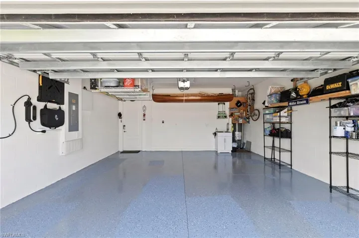 Well organized garage with extra storage and added utility sink