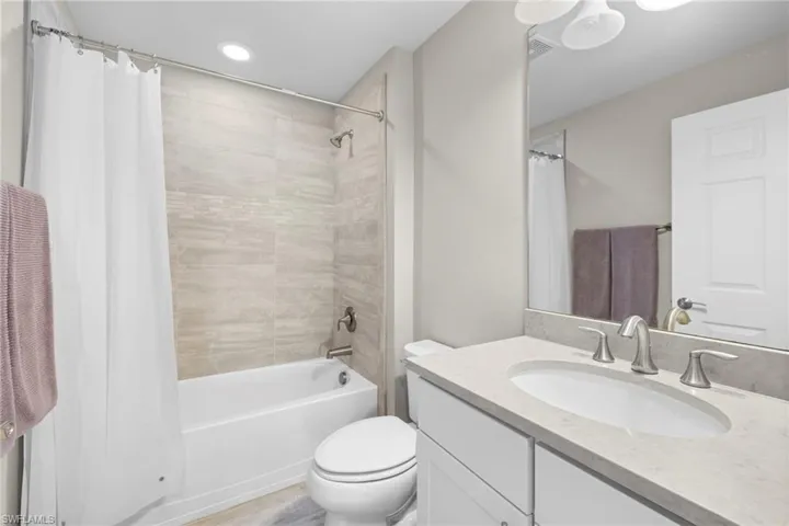 Upstairs Full bath featuring shower / tub combo with curtain and vanity