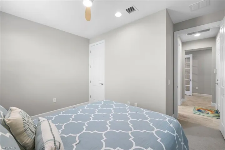 guest bedroom with a ceiling fan and recessed lighting
