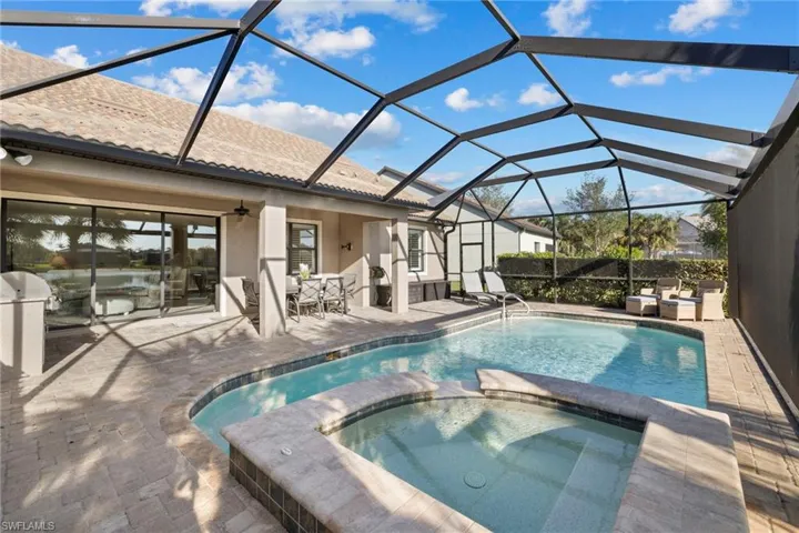 View of pool with a sunroom, a patio area, a ceiling fan, a pool with connected hot tub, and a lanai