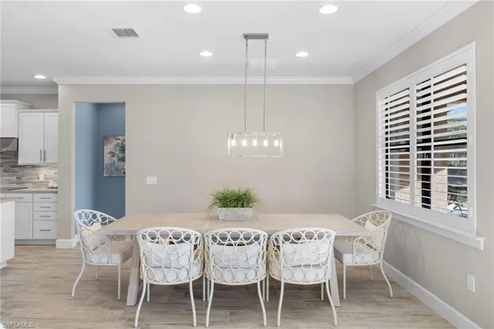 Dining room featuring crown molding, recessed lighting, and light wood finished floors