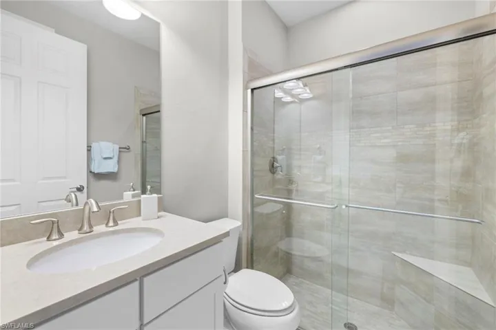 Full guest bath featuring a shower stall and vanity