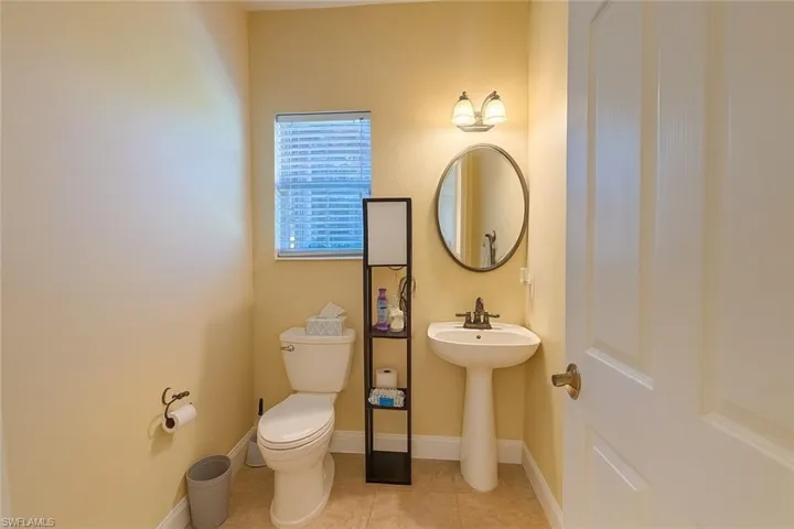 Bathroom featuring light tile patterned floors and baseboards