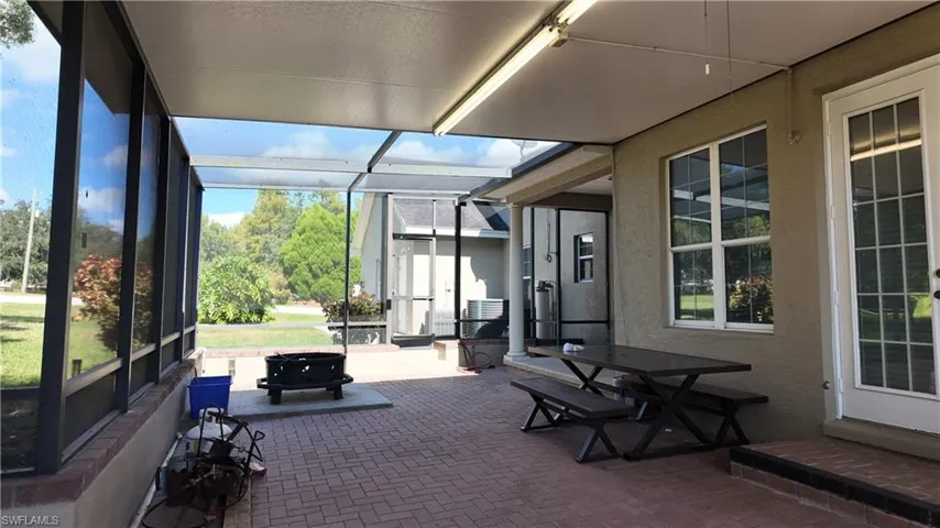 Sunroom / solarium featuring a patio area