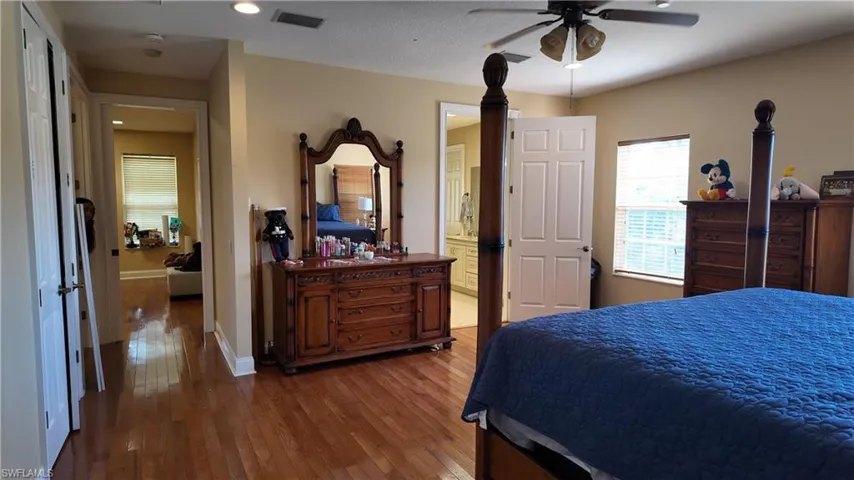 Bedroom with dark wood-type flooring, recessed lighting, and a ceiling fan