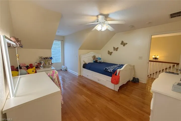 Bedroom featuring light wood-style floors, a ceiling fan, and vaulted ceiling