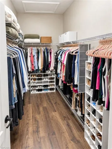 Wood-finish flooring, white walls, built-in wire shelving, and integrated shoe storage