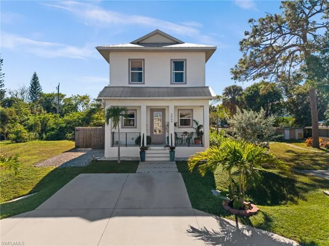 View of front of house with a porch and a front lawn