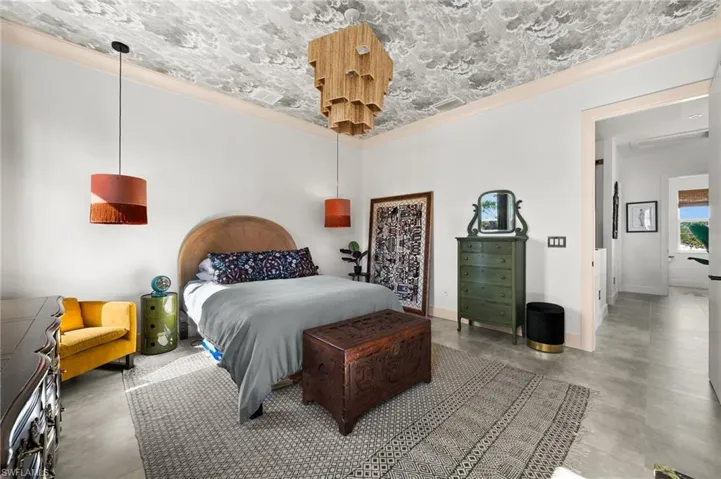 Bedroom featuring concrete floors and ornamental molding