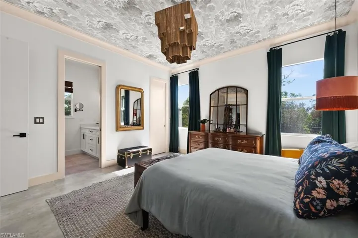 Bedroom featuring ensuite bath and crown molding