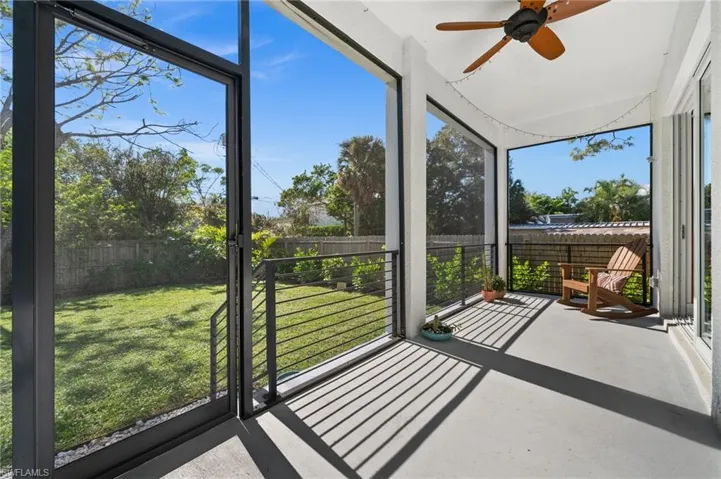Unfurnished sunroom featuring a wealth of natural light and ceiling fan