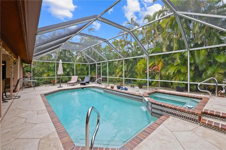 Refinished Lanai surface with Waterfall Spa. You'll get tired of this Pool setup .. never