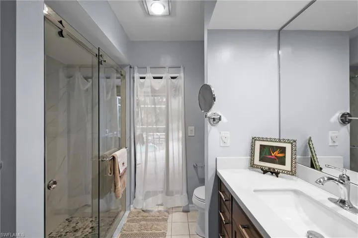 Primary Bathroom with sweet vanity & luxury Glass Shower Door