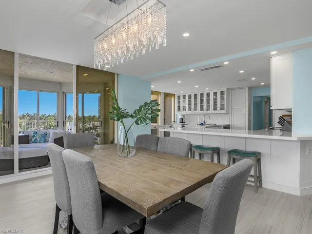 Dining room with recessed lighting, light wood-style floors, and a chandelier