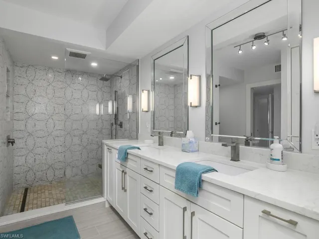 Full bathroom with a walk in shower, double vanity, and recessed lighting