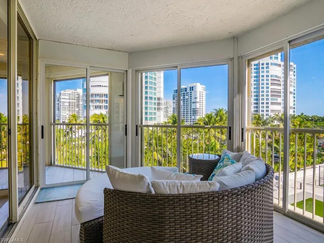 Sunroom with a city view, healthy amount of natural light, and a textured ceiling