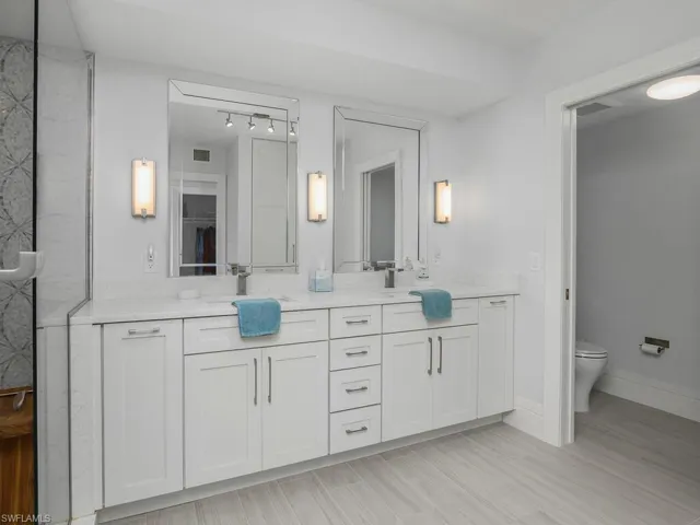 Bathroom featuring double vanity and toilet
