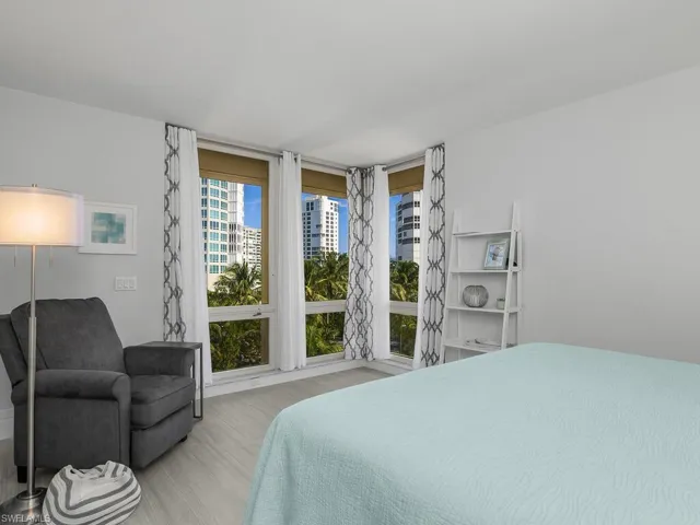 Bedroom featuring wood finished floors and a city view