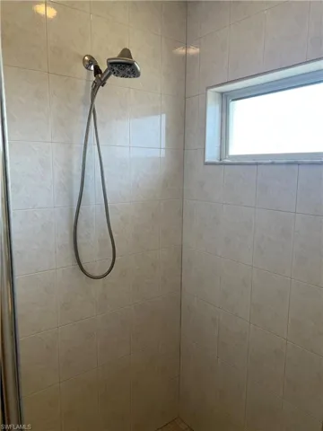 Full bath featuring tiled shower