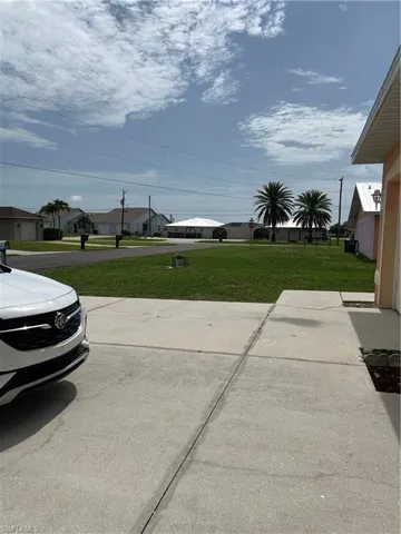 View of green lawn with a street view