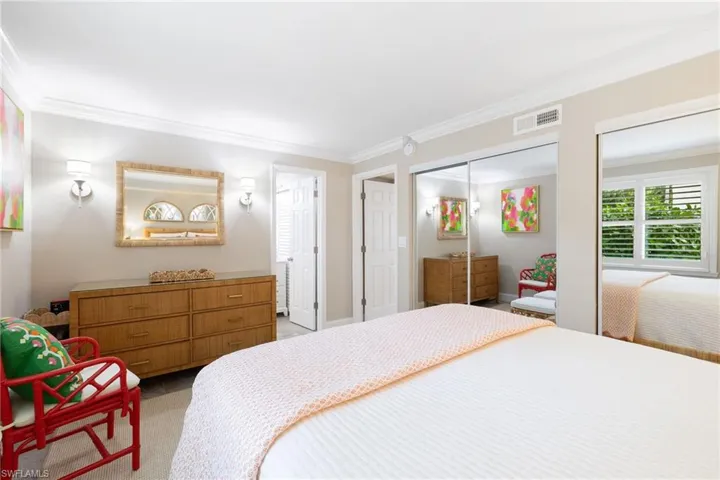 Bedroom featuring crown molding and light colored rug