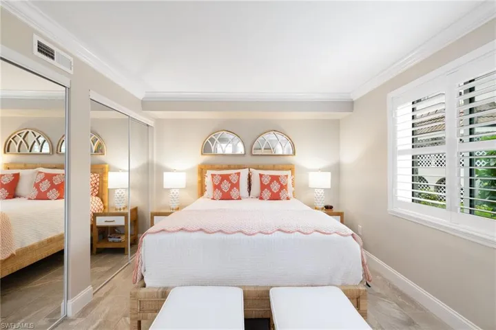 Bedroom featuring two closets and ornamental molding
