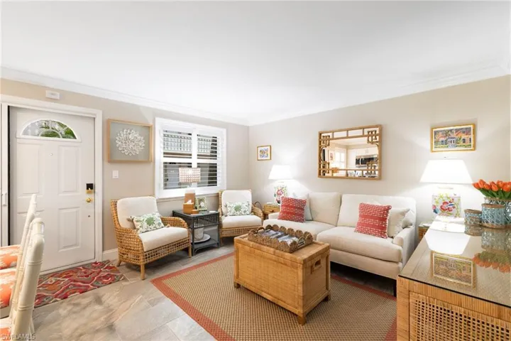 Living room featuring crown molding and healthy amount of natural light