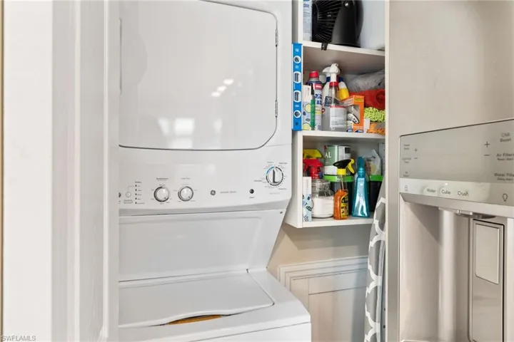 Laundry room with stacked washer and clothes dryer