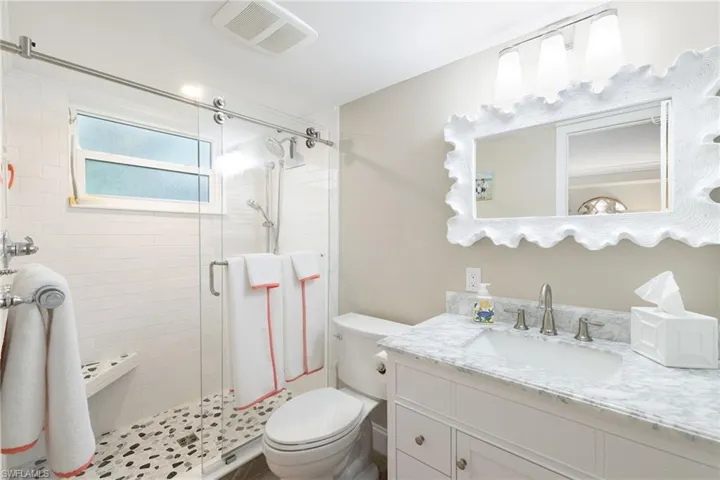 Bathroom featuring vanity and a shower