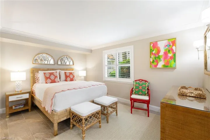 Bedroom featuring ornamental molding and baseboards