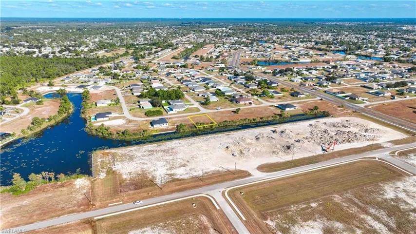 View of property location with a large body of water and nearby suburban area