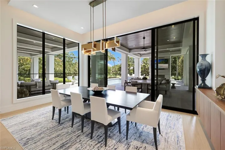 Dining room with plenty of natural light, light wood-style floors, and recessed lighting