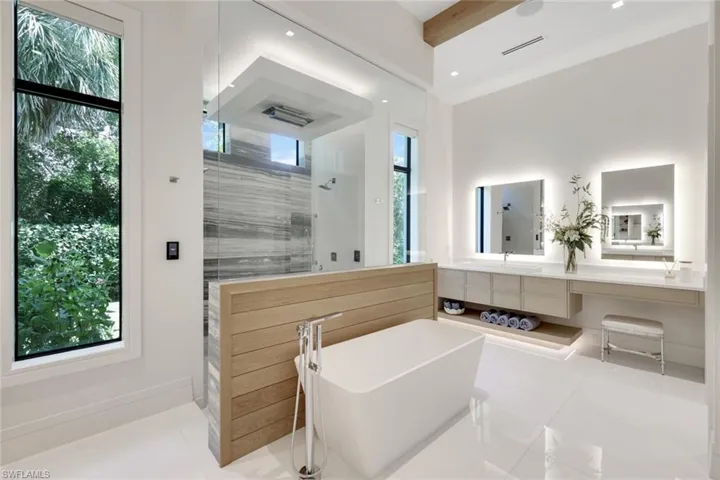 Bathroom with healthy amount of natural light, tile patterned floors, and walk in shower