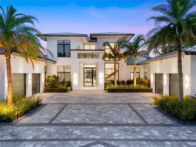 Contemporary home featuring decorative driveway, stucco siding, and a garage