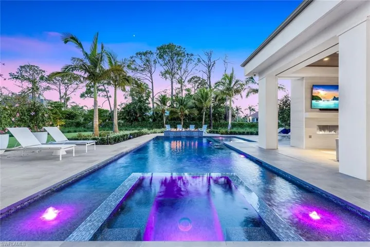 View of swimming pool featuring a patio and a pool with connected hot tub