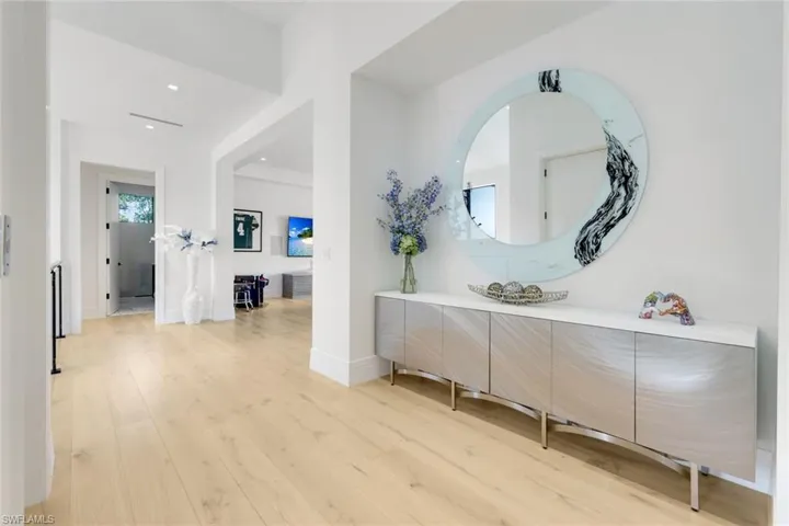 Hall featuring light wood-style flooring, recessed lighting, and baseboards