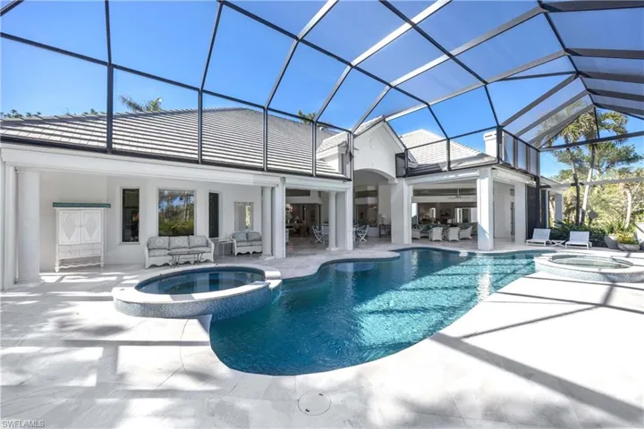 View of pool featuring a patio area, a lanai, an outdoor hangout area, and an in ground hot tub