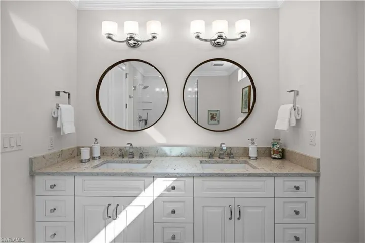 Bathroom featuring vanity and crown molding
