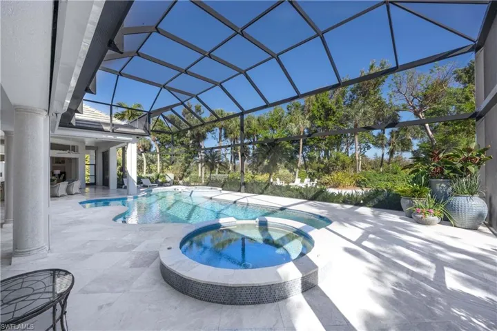 View of swimming pool featuring ceiling fan, a lanai, an in ground hot tub, and a patio