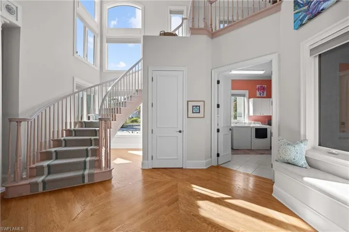 Foyer featuring a towering ceiling and a healthy amount of sunlight