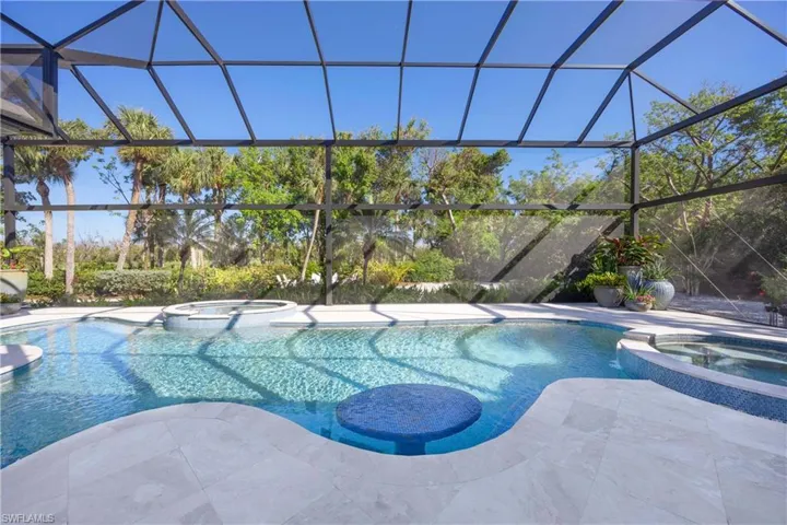 View of pool featuring a lanai and an in ground hot tub