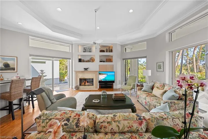 Living room with ceiling fan, light hardwood / wood-style flooring, and plenty of natural light